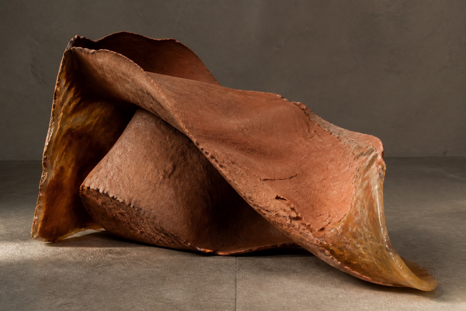 Original concept study of folded terracotta clay and translucent resin