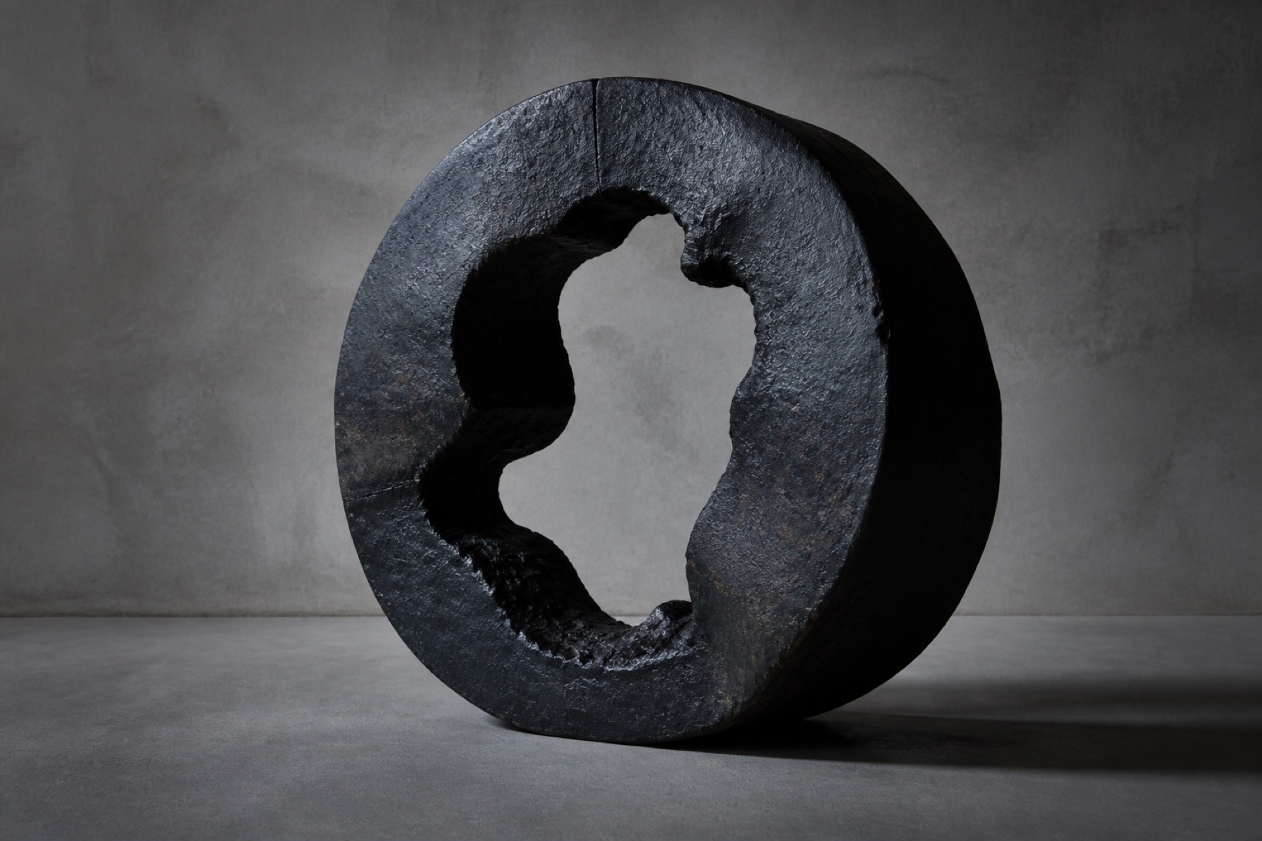 Original concept study of a dark cast-metal ring with an irregular opening